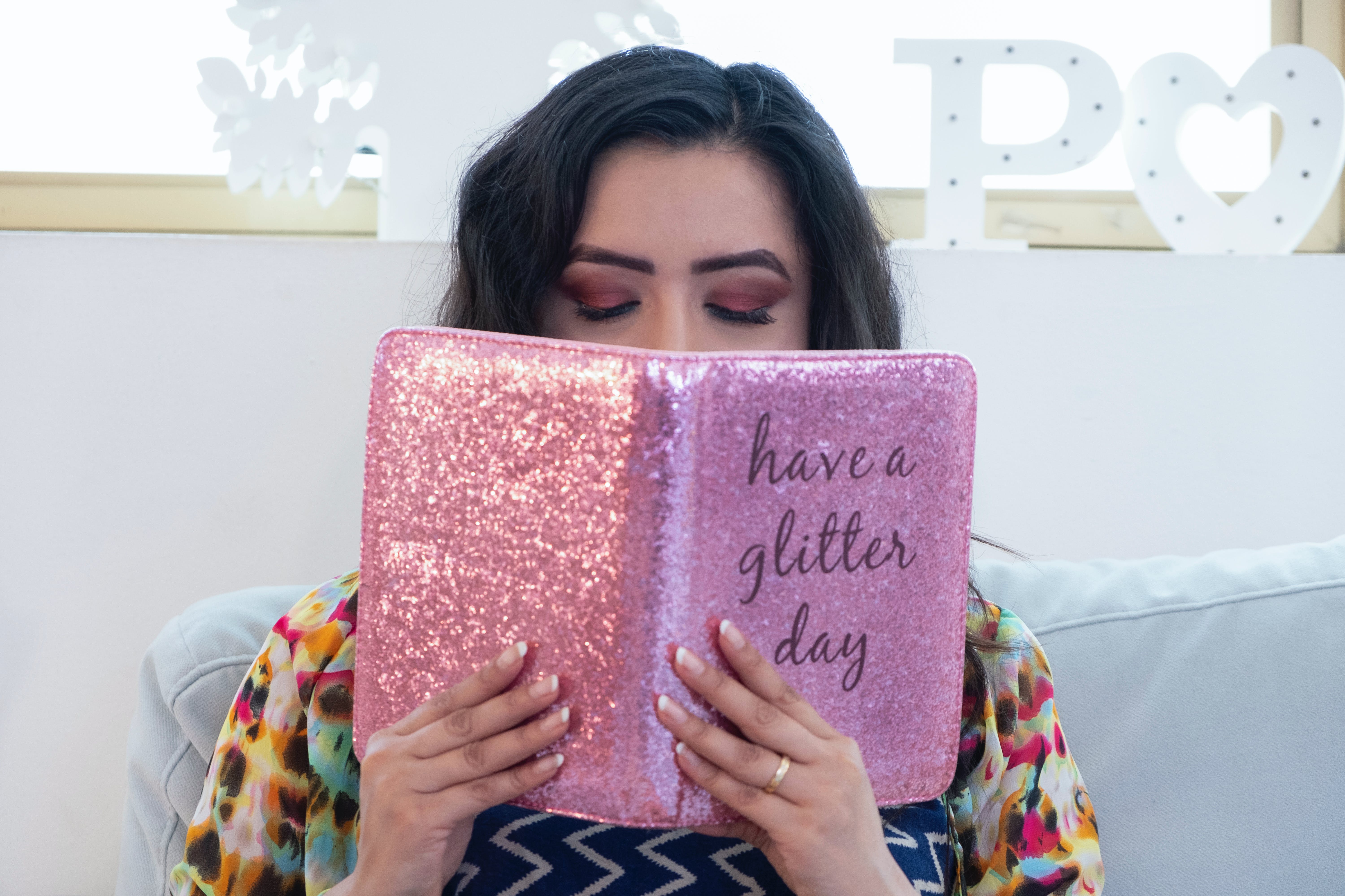 woman reading pink book